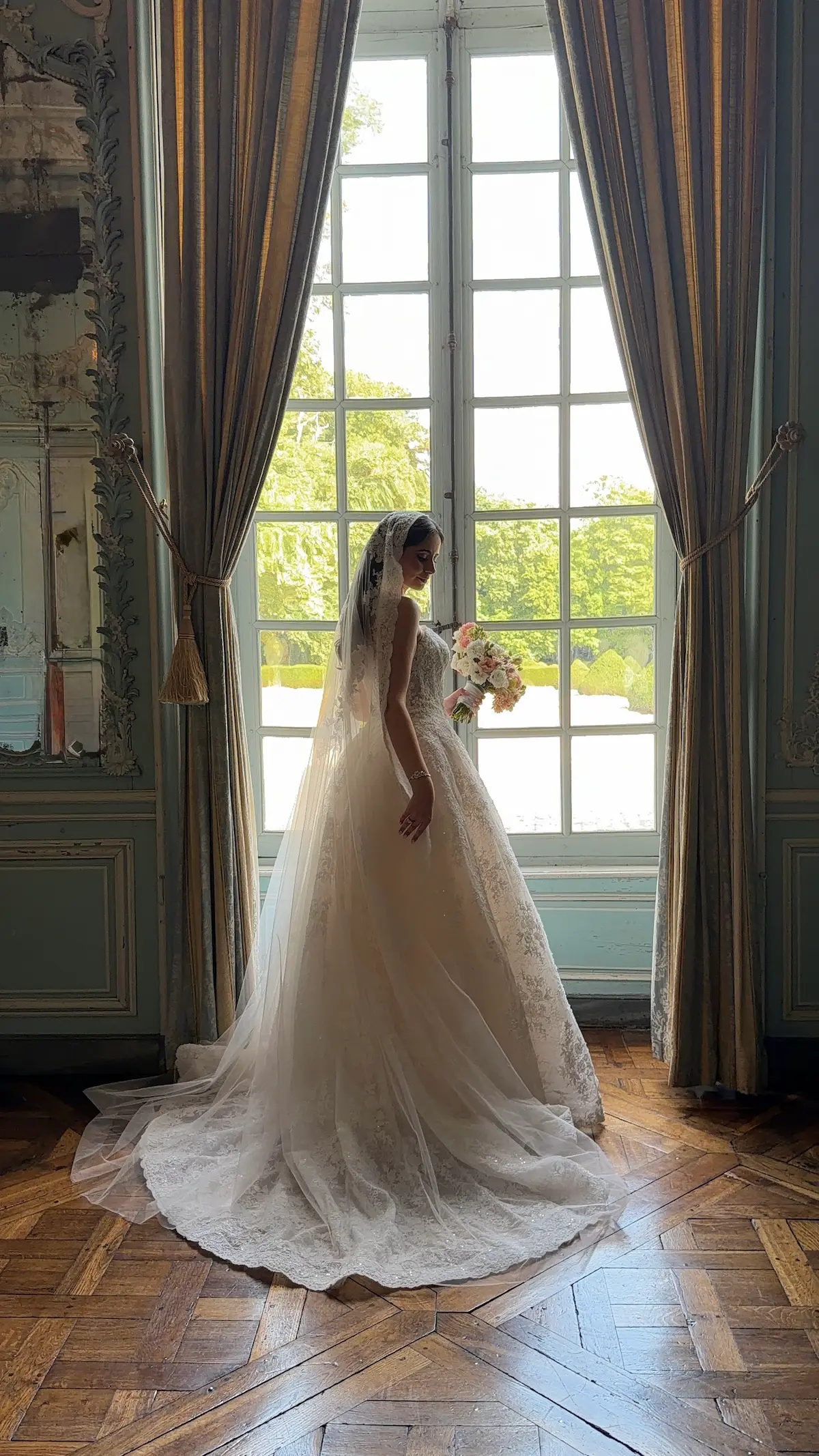 Bride getting ready in front of a window
